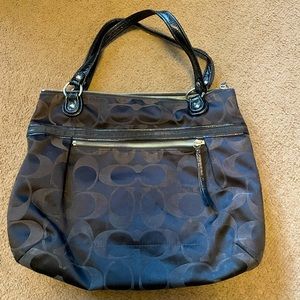 Black coach shoulder bag. Logo all over. Solver zippers.